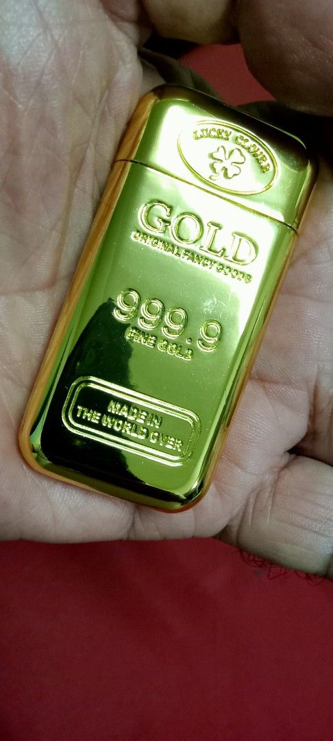 Lucky Clover Gold Bar Lighter (Category: Vintage Collectibles) located in Taytay. Submitted by joselaquino (Listing ID 1455059308, Image 1). Description: Cool lighter shaped like a gold bar. Says 'GOLD 999.9 FINE GOLD' on it. Also says 'MADE IN THE WORLD OVER'. Lights up with a blue flame. Great novelty item. Fun to have..
