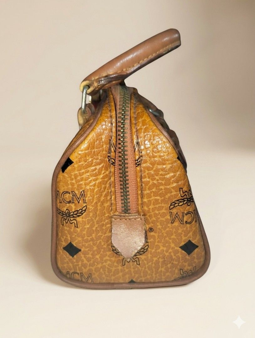 Vintage MCM Monogram Mini Boston Bag (Category: Luxury Bags & Wallets) located in Pasig City. Submitted by kat_grande (Listing ID 1455014916, Image 3). Description: - Classic MCM monogram mini Boston bag - Color: Brown and black - Features leather trim and handles - Secure zipper closure - Compact size, ideal for carrying essentials - A unique vintage statement piece - No bag authenticity..