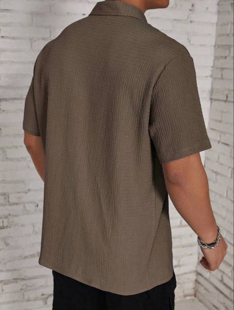 Men's Casual Button Down Polo (Category: Tshirts & Polo Shirts ) located in Manila. Submitted by twabkeve (Listing ID 1454959390, Image 3). Description: - Cool textured short sleeve shirt - Nice earthy brown color - Button-up front with classic collar - Versatile: dress up or down - Perfect for casual outings or a relaxed vibe - Easy to pair with shorts or pants.