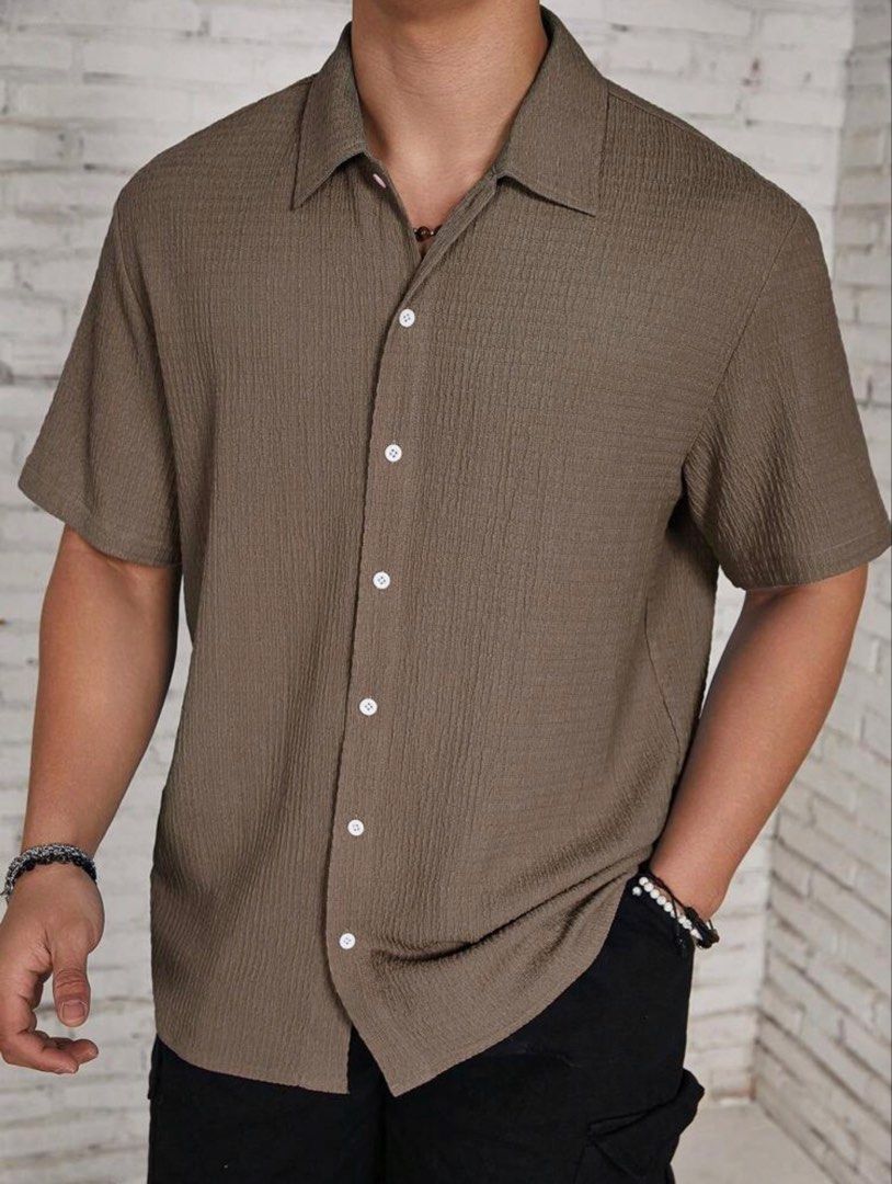 Men's Casual Button Down Polo (Category: Tshirts & Polo Shirts ) located in Manila. Submitted by twabkeve (Listing ID 1454959390, Image 2). Description: - Cool textured short sleeve shirt - Nice earthy brown color - Button-up front with classic collar - Versatile: dress up or down - Perfect for casual outings or a relaxed vibe - Easy to pair with shorts or pants.