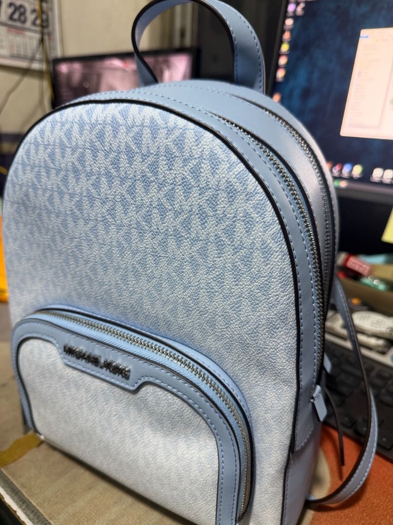 Michael Kors Jaycee MD Zip Pocket Backpack LT SKY (Category: Backpacks) located in Muntinlupa City. Submitted by zerolock (Listing ID 1455058112, Image 2). Description: - Authentic Michael Kors Jaycee Backpack - Color: Light Sky Blue - Signature MK all-over logo print - Convenient front zip pocket - Adjustable straps for comfortable wear - Includes original care card and tech accessory info card - Original MSRP: $358.00 - No Issue ~ never been us