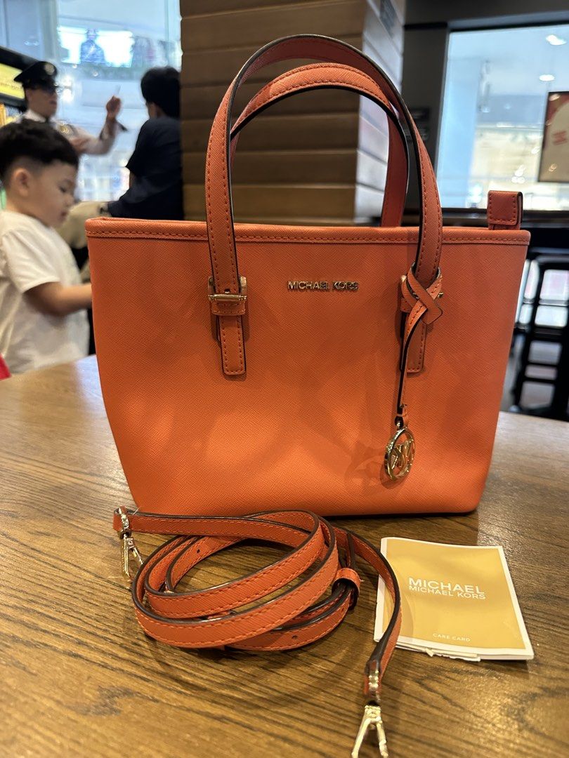 Michael Kors Orange Leather Tote Bag with Strap (Category: Luxury Bags & Wallets) located in Antipolo. Submitted by santigao25 (Listing ID 1455003405, Image 1). Description: - Authentic Orange Michael Kors Tote Bag - Made of premium textured leather - Features a long, adjustable strap for versatile wear - Adorned with the iconic Michael Kors MK charm - Comes with the original care card - Ideal for everyday use, stylish and practical.