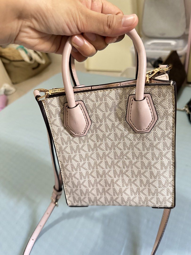 Michael Kors XS mini sling bag (Category: Luxury Bags & Wallets) located in Valenzuela. Submitted by shopwithmika (Listing ID 1454970337, Image 3). Description: - Authentic Michael Kors XS Shopper tote bag - Classic MK monogram print - Top handles - Detachable crossbody strap - Interior card slots - Gold hardware details - Ideal for everyday use or a night out.