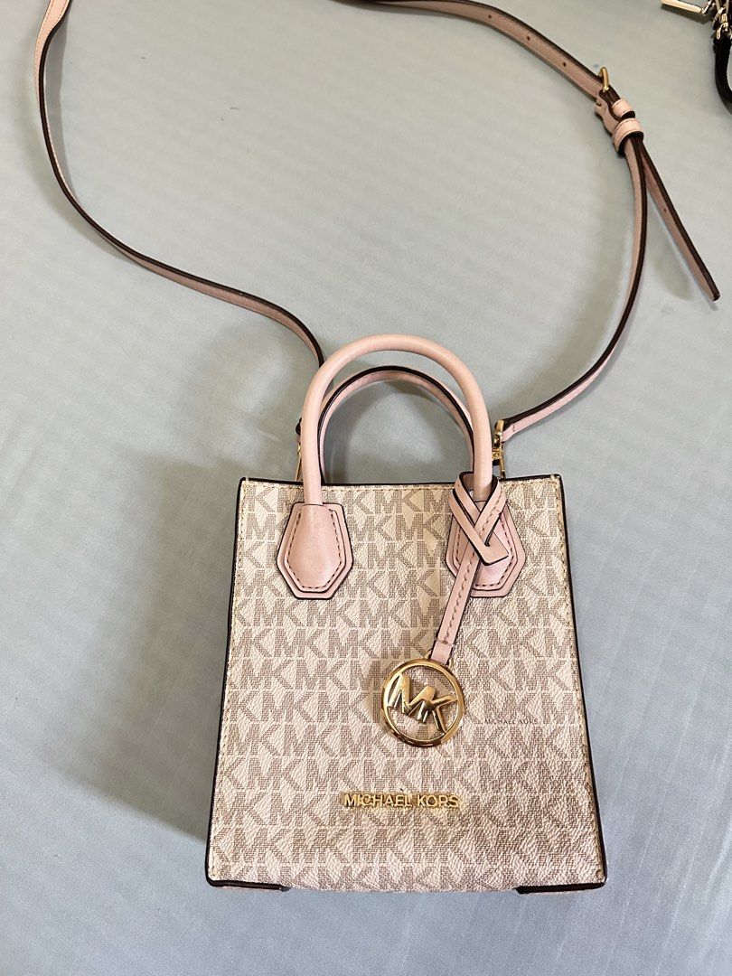 Michael Kors XS mini sling bag (Category: Luxury Bags & Wallets) located in Valenzuela. Submitted by shopwithmika (Listing ID 1454970337, Image 1). Description: - Authentic Michael Kors XS Shopper tote bag - Classic MK monogram print - Top handles - Detachable crossbody strap - Interior card slots - Gold hardware details - Ideal for everyday use or a night out.