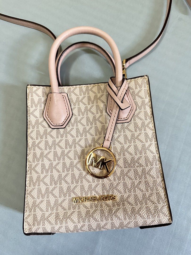Michael Kors XS mini sling bag (Category: Luxury Bags & Wallets) located in Valenzuela. Submitted by shopwithmika (Listing ID 1454970337, Image 2). Description: - Authentic Michael Kors XS Shopper tote bag - Classic MK monogram print - Top handles - Detachable crossbody strap - Interior card slots - Gold hardware details - Ideal for everyday use or a night out.