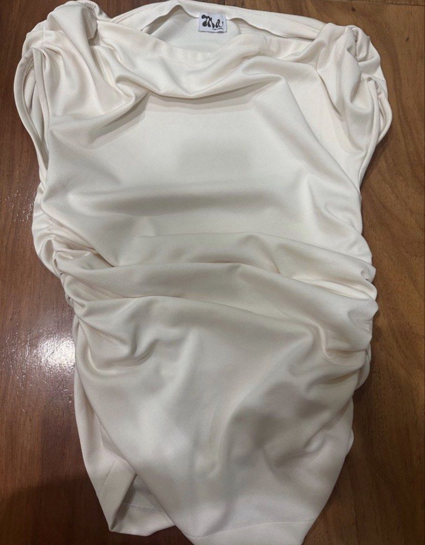 Miu the Label Stargirl Top in White (Category: Others Tops) located in Manila. Submitted by clothesoft (Listing ID 1455107033, Image 2). Description: - Last price listed, will not entertain other offers Bust - 36 inches, Waist - 31 inches, Length 14 inches —- Cream colored top - All-over ruched detailing - Off-shoulder design - Chic and dressy look - Versatile for various styling options - Ideal for nights out or special occasions.