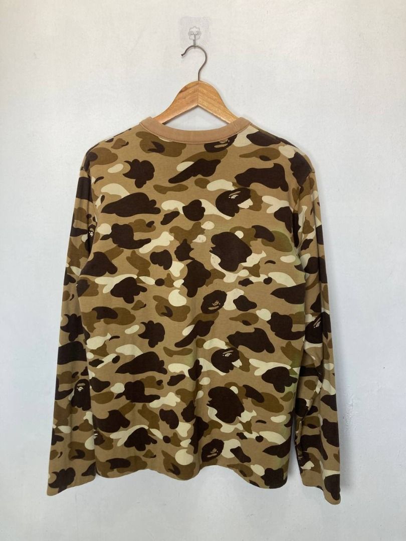 OG Bape 1st Camou Reversible Sweatshirt (Category: Sleep and Loungewear) located in Quezon City. Submitted by stylenpick (Listing ID 1455131274, Image 3). Description: Brand: Bape Made in: Japan Year: 2007 Material: Cotton Color: Brown Marked size: Sizing: Measurements (laid flat): Shoulders: 18" Sleeves: 25” Width: 20” Hem: 21" Length: 27” Color rating: 8/10 Condition: 8/10 Flaws: stain/discoloration, signs of usage .