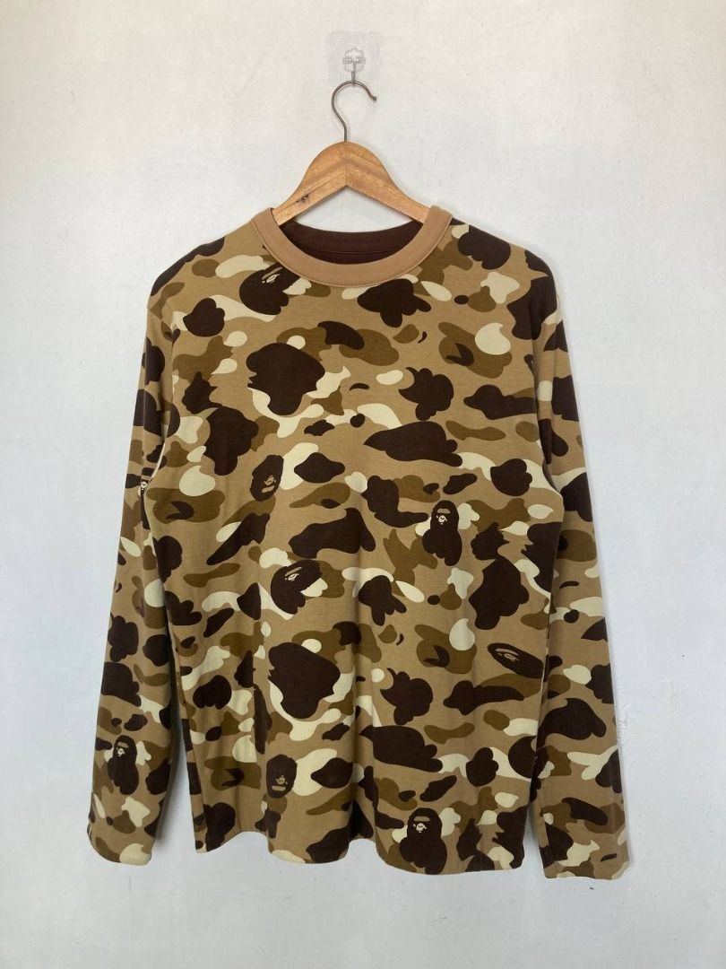 OG Bape 1st Camou Reversible Sweatshirt (Category: Sleep and Loungewear) located in Quezon City. Submitted by stylenpick (Listing ID 1455131274, Image 2). Description: Brand: Bape Made in: Japan Year: 2007 Material: Cotton Color: Brown Marked size: Sizing: Measurements (laid flat): Shoulders: 18" Sleeves: 25” Width: 20” Hem: 21" Length: 27” Color rating: 8/10 Condition: 8/10 Flaws: stain/discoloration, signs of usage .