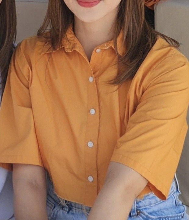Orange Cropped Button-Up Shirt with Raw Hem (Category: Shirts) located in Manila. Submitted by xiaauma (Listing ID 1455100833, Image 3). Description: - Orange cropped shirt - Short sleeves - Collared neckline - Button-up front - Raw hem detail - Perfect for pairing with high-waisted bottoms - Casual and stylish piece.