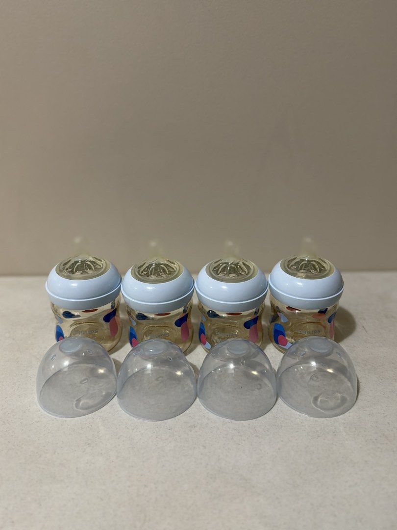 Philips Avent Baby Bottles Set (Category: Breastfeeding & Bottle Feeding) located in Taytay. Submitted by thestyletwins (Listing ID 1455088126, Image 3). Description: - Set of 4 Philips Avent baby bottles - Comes with protective caps - Clear bottles with blue accents - Features measurement markings for easy feeding.