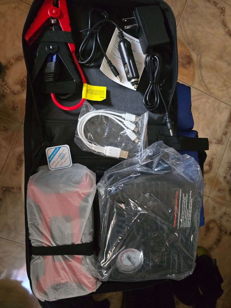 POWER Car Jump Starter Kit with Air Compressor (Category: Other Automotive Parts and Accessories) located in Valenzuela. Submitted by heatnotburn (Listing ID 1454990291, Image 2). Description: - Portable jump starter kit for car emergencies. - Includes jump cables, car charger, USB cables, and wall adapter. - Built-in air compressor with gauge for tire inflation. - All components neatly stored in a zippered case. location Valenzuela near qc.