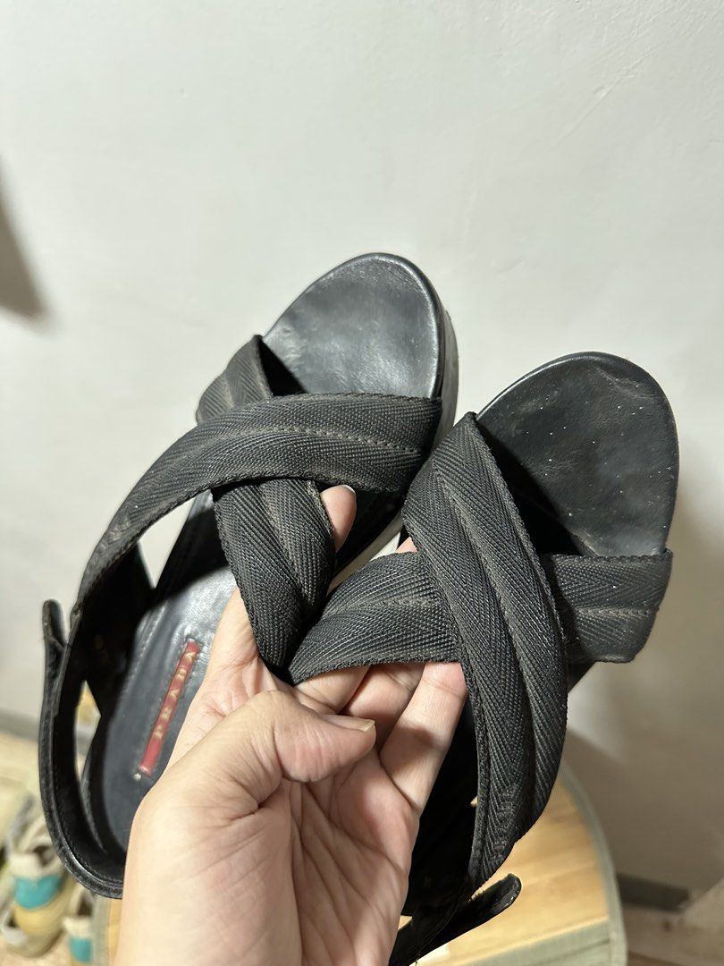 Prada Black Wedge Sandals (Category: Sneakers & Footwear) located in Quezon City. Submitted by phinksummercollectionbackup (Listing ID 1455088613, Image 3). Description: - Authentic Black Prada Wedge Sandals - Comfortable fabric criss-cross straps over the foot - Secure slingback strap with adjustable buckle closure - Stylish platform wedge heel - Classic Prada logo detail on the insole - Perfect for elevating both casual and formal looks.
