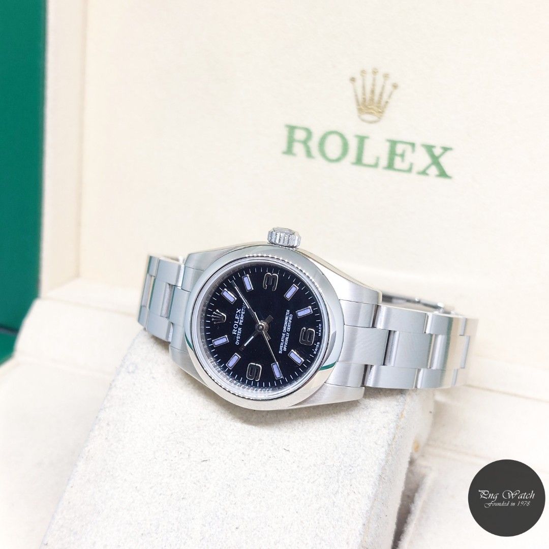 Rolex 26mm Black Dial Oyster Perpetual REF: 176200 (2009) (Category: Watches) located in Singapore. Submitted by pngwatchdealer (Listing ID 1455124192, Image 2). Description: [SPECIFICATIONS] **Watch comes in full option (Box and Card)** **Rehaut ring** **Factory caseback sticker intact** Brand: Rolex Model: Oyster Perpetual 26mm Black Arabic & Batons Dial (REF: 176200)(Z)(09)(O) Movement: Automatic (Self-Winding) Functions and Features: Hours, M