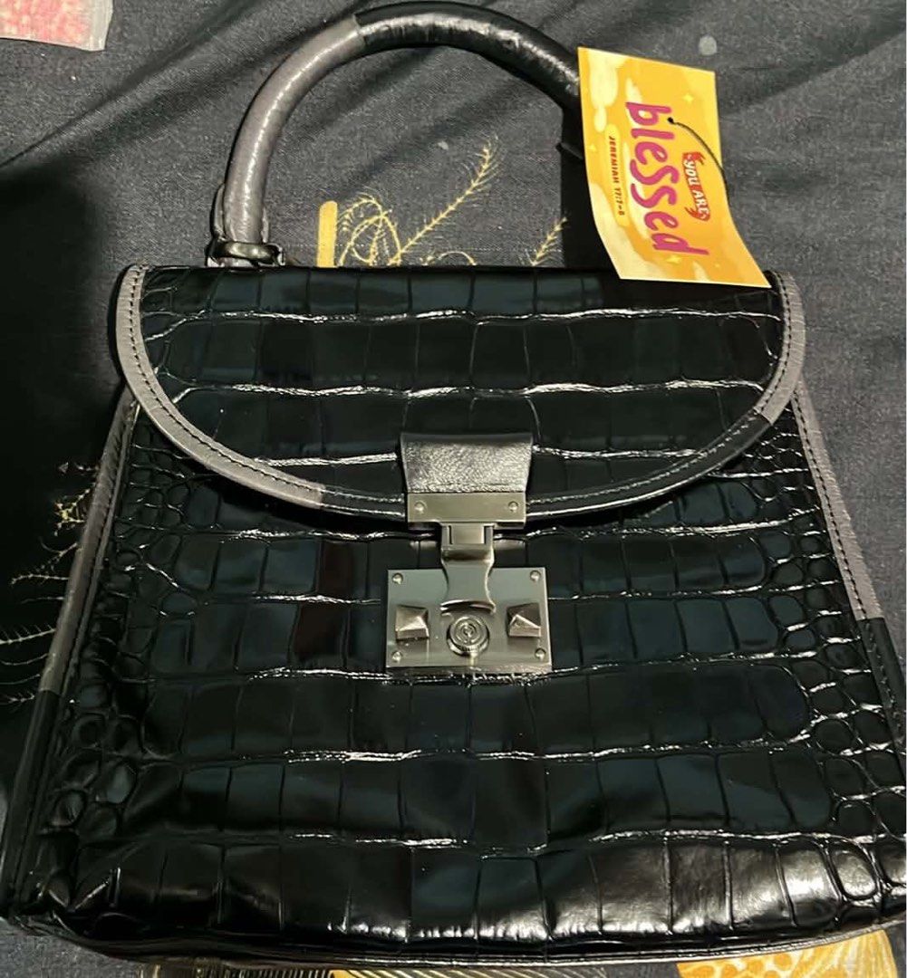 Rouge Lounge Black Croc Embossed Top Handle Bag (Category: Luxury Bags & Wallets) located in Cagayan de Oro. Submitted by apbeja (Listing ID 1455138717, Image 1). Description: - Black croc-embossed handbag by Rouge Lounge - Structured top handle - Secure clasp closure - Soft interior lining - Classic and versatile design - Comes with a dust bag.