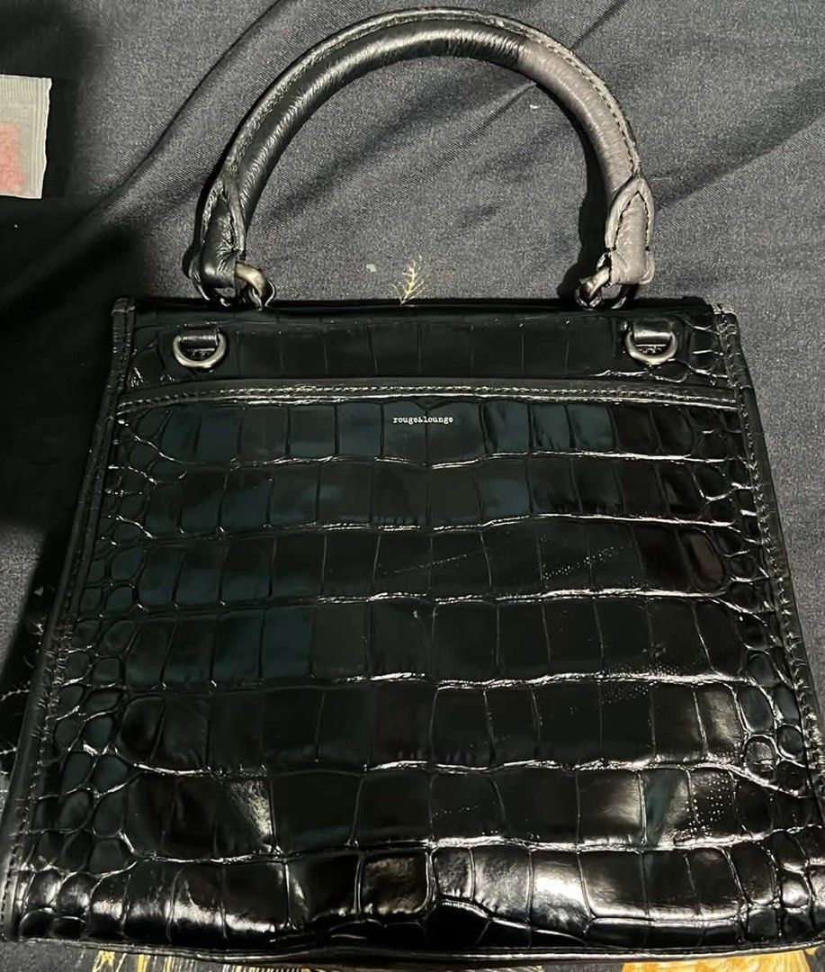 Rouge Lounge Black Croc Embossed Top Handle Bag (Category: Luxury Bags & Wallets) located in Cagayan de Oro. Submitted by apbeja (Listing ID 1455138717, Image 2). Description: - Black croc-embossed handbag by Rouge Lounge - Structured top handle - Secure clasp closure - Soft interior lining - Classic and versatile design - Comes with a dust bag.