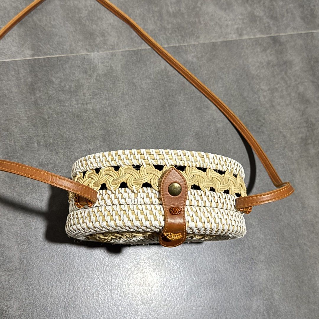 Round Rattan Bag with Leather Strap and Batik Lining (Category: Cross-body Bags) located in Davao. Submitted by wisedeer-bcd8 (Listing ID 1454987624, Image 3). Description: - Cute round rattan bag - Natural woven material - Patterned batik lining inside - Leather strap and closure detail - Great for beach trips or casual outings - Unique design.