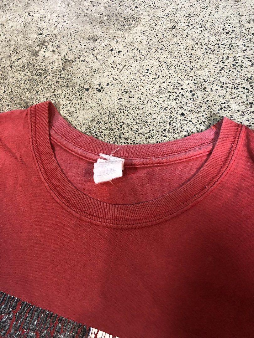 Scarface (Category: Tshirts & Polo Shirts ) located in San Jose. Submitted by mightycloud-7dc0 (Listing ID 1455019014, Image 3). Description: - Red t-shirt with a unique cracked graphic print on the front. - Features a small tear on the left sleeve near the hem. - Tag is present but unreadable. - Perfect for everyday casual wear..