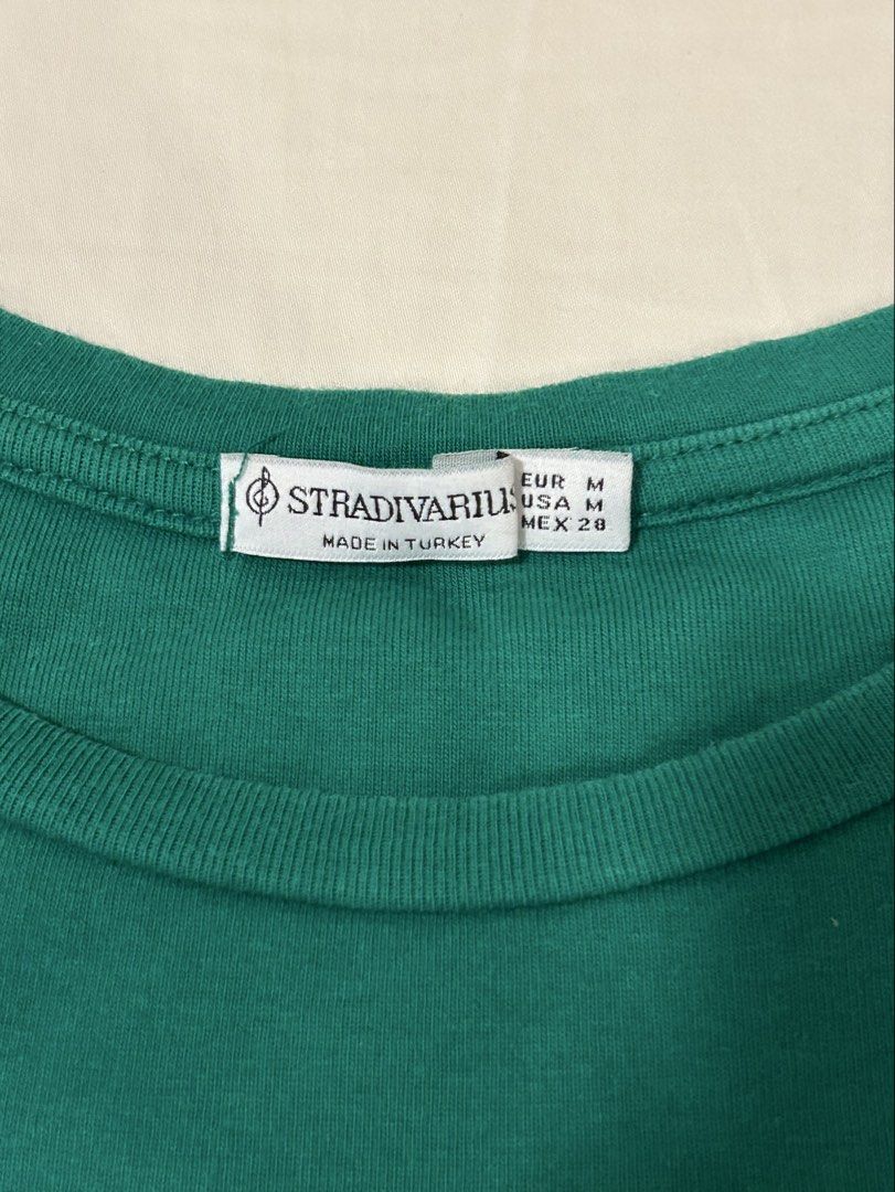 Stradivarius Green T-shirt (Category: Shirts) located in Quezon City. Submitted by m4delineee (Listing ID 1455125904, Image 2). Description: - size: M - basic tee, is emerald green IRL (looks blue-ish in pic) - thick cotton material.