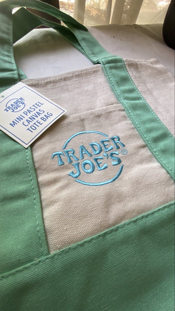 Trader Joe's Mini Pastel Canvas Tote Bag (Category: Tote Bags) located in Davao. Submitted by iam_artisan (Listing ID 1455020696, Image 2). Description: - Cute mini tote bag from Trader Joe's - Natural canvas with pastel green accents - Features a small front pocket - Perfect for carrying essentials, quick errands, or as a lunch bag - Brand new with original tag attached.