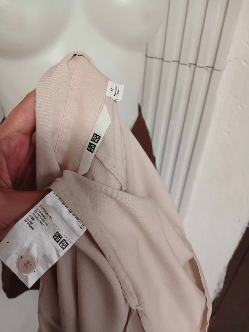 UNIQLO RAYON SHORT SLEEVE - BEIGE (Category: Shirts) located in Makati City. Submitted by vertaronda (Listing ID 1455118020, Image 2). Description: - Uniqlo Short-Sleeved Button-Up Shirt - Color: Light Beige - Size: Medium (M) - Material: Comfortable fabric - Style: Classic, versatile for casual wear or layering - Easy to pair with various bottoms.