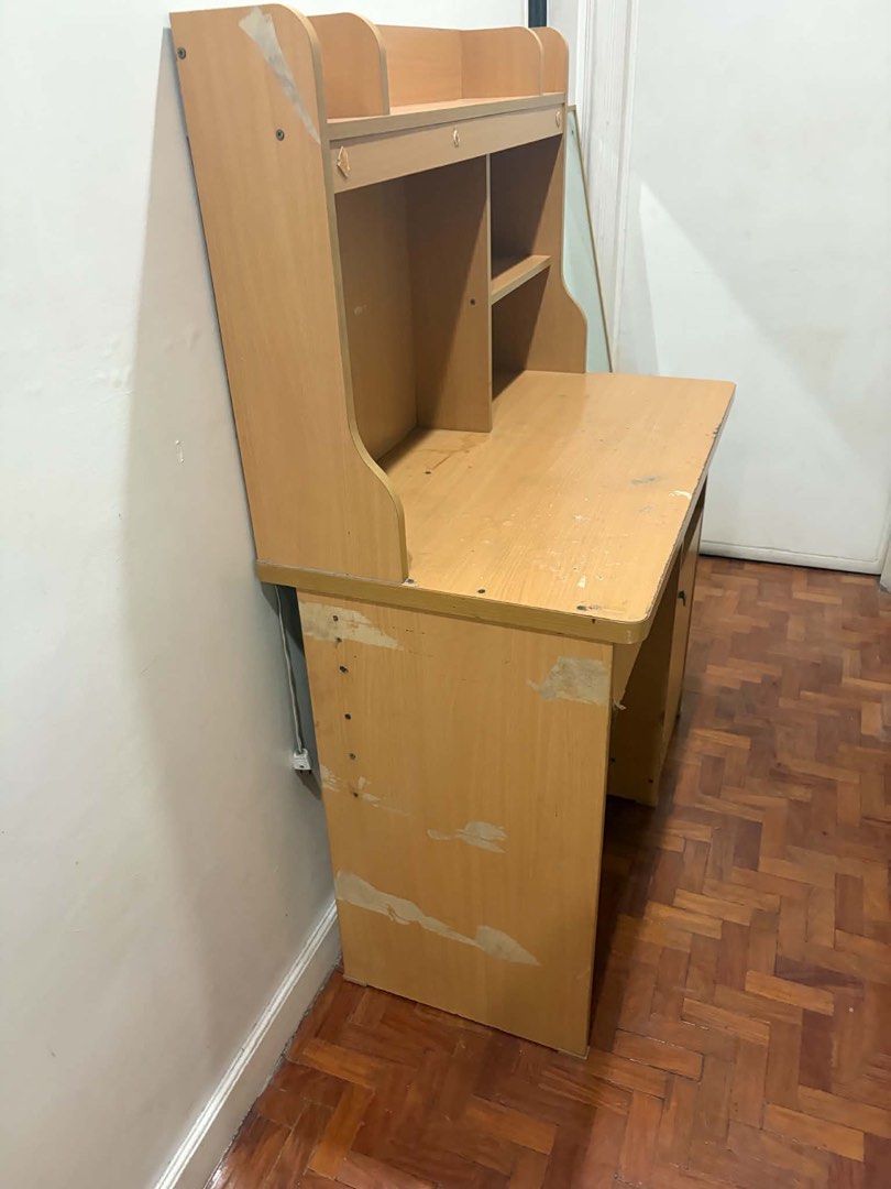 Used Study Desk with Shelves (Category: Tables & Sets) located in Quezon City. Submitted by mikaela_0 (Listing ID 1455075975, Image 1). Description: - Wooden study desk with hutch - Multiple shelves for storage - Includes one drawer and a cabinet with a door - Surface shows some marks and wear - Laminate peeling on the sides - Drawer slides need repair - Ideal for students or home office - Requires some minor restoration (TLC) - Price is negotiab