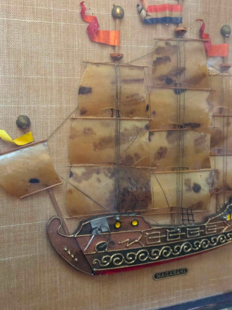 Sale! Vintage 3D Sailing Ship Wall Hanging 14x12" (Category: Wall Decor) located in Cainta. Submitted by elainelawenko (Listing ID 1454970587, Image 2). Description: - Vintage wall hanging featuring a 3D sailing ship model. - Dimensions: 14 inches x 12 inches. - Ship boasts detailed sails and flags. - 'Nagasaki' is visible on the ship. - A unique decorative piece for your wall..