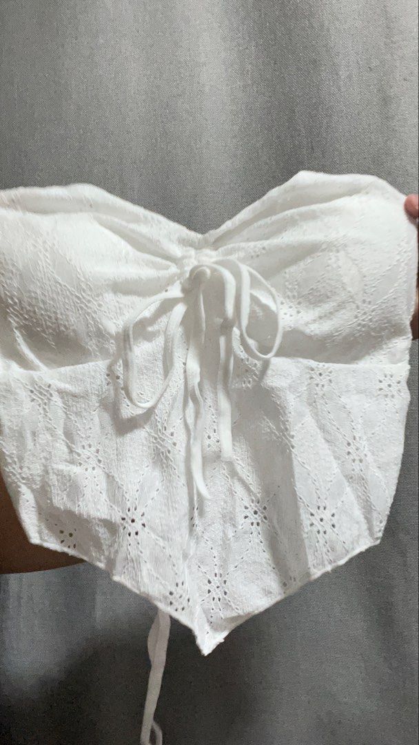 White Eyelet Lace Corset Bustier Crop Top (Category: Sleeveless) located in Manila. Submitted by _littlebunny (Listing ID 1455086012, Image 2). Description: - White eyelet lace crop top - Sweetheart neckline with tie front - Adjustable tie at the back for a custom fit - Scalloped hemline - Versatile: pairs well with high-waisted jeans or skirts - Ideal for summer days and nights out.