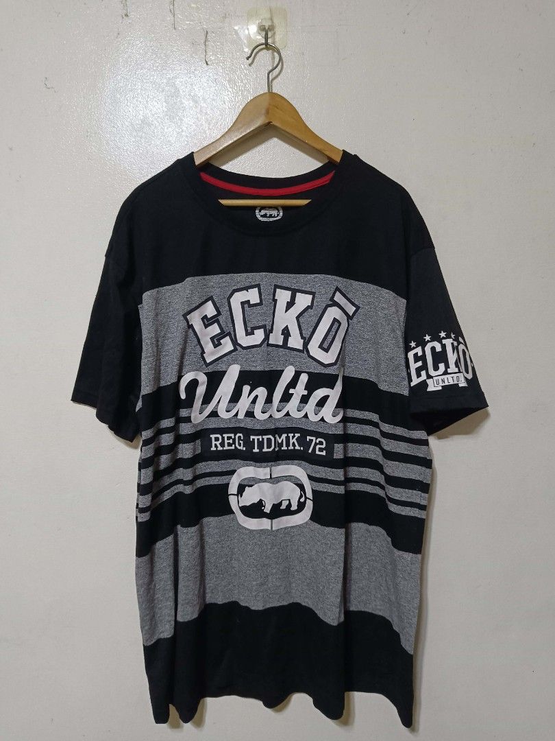 Y2k Ecko Unltd. Graphic T-Shirt 3XL (Category: Tshirts & Polo Shirts ) located in Caloocan City. Submitted by Tulokss (Listing ID 1455119444, Image 2). Description: - Brand: Ecko Unltd. - Size: 3XL - Color: Black and grey stripes - Design: Features Ecko logo and text graphics on front and sleeve - Material: Made in China - Occasion: Great for casual wear issue : lints.