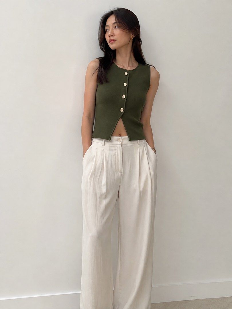 Zara Green Button Up Knit Cropped Top (Category: Coats, Jackets and Outerwear) located in Taguig. Submitted by hertrinkets (Listing ID 1454414902, Image 3). Description: - Zara olive green knit cropped cardigan - Sleeveless design - Silver button details down the front - Perfect for layering or wearing solo - Highly versatile piece.