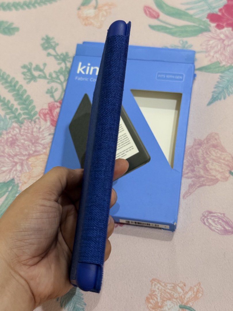 Amazon Kindle Fabric Cover for 10th Gen Kindle (Category: E-Readers) located in Hermosa. Submitted by bookwormhermosa (Listing ID 1455261118, Image 2). Description: - Blue fabric cover for 10th Gen Kindle - Protects your device - Snug fit - Comes with original packaging - Keeps your Kindle safe and looking good.