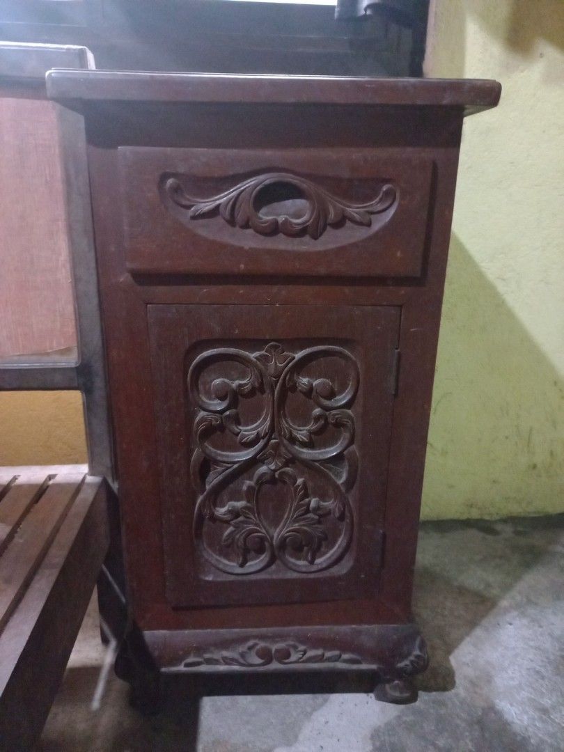 Narra headboard and 2 narra side table/cabinets (Category: Shelves, Cabinets & Racks) located in Cavite. Submitted by ellave (Listing ID 1455174829, Image 3). Description: - Beautiful wooden shelf with detailed side carvings. - Multiple compartments for ample storage. - Rich, dark wood finish. - Ideal for displaying books or decorative items. - 2 side tables/cabinet Price negotiable .