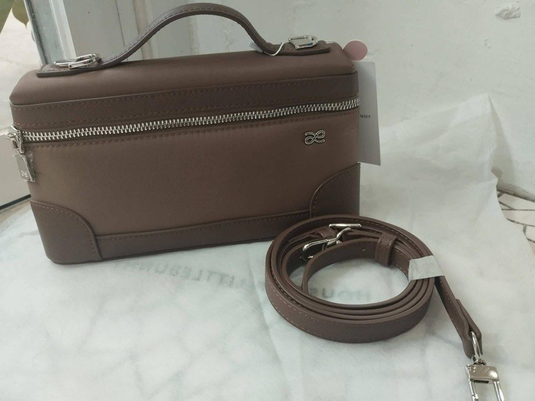 Anya Hindmarch Vanity Case Bag (Category: Luxury Bags & Wallets) located in Las Pinas. Submitted by the_caring_closet (Listing ID 1455143166, Image 1). Description: - Authentic Anya Hindmarch brown vanity case bag - Detachable crossbody strap included - Elegant silver hardware - Secure zip closure - Iconic Anya Hindmarch bow logo - Ideal for travel or everyday use - Brand new with tags still attached.
