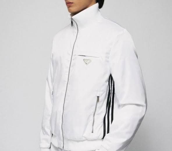 Authentic Prada Adidas Collab White Track Jacket (Category: Luxury Apparel) located in Manila. Submitted by jun.cotoco (Listing ID 1455143160, Image 2). Description: - Authentic Prada Adidas track jacket - Iconic Prada triangle logo on chest - Black stripes down the sleeves - Full zip closure with high collar - Two zip pockets on the front - Sharp and stylish design - Complete with Prada cover, hanger and tag - Bought for US$ 1200 - Guaranteed Or