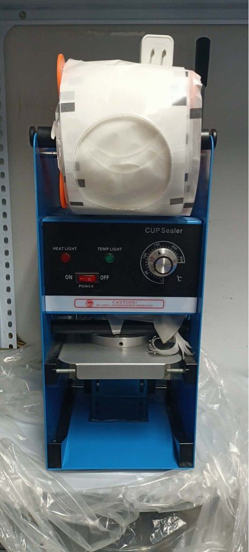 Automatic Cup Sealer Machine for Drinks (Category: Other Kitchen Appliances) located in Taguig. Submitted by krungy19 (Listing ID 1455164154, Image 2). Description: - Perfect for bubble tea shops and beverage businesses. - Seals cups securely with plastic film. - Comes with one roll of sealing film. - Features adjustable temperature settings for various cup materials. - Simple lever operation for ease of use. - Tested and works well..
