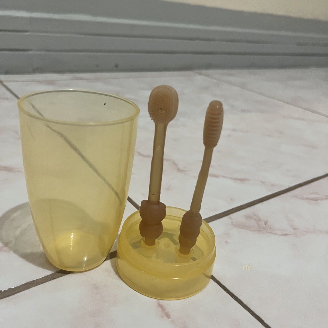 Baby Silicone Toothbrush Set with Case (Category: Oral Care) located in Taguig. Submitted by belinda.space (Listing ID 1455275184, Image 1). Description: - Includes 2 silicone toothbrushes (spoon-shaped and bristle) and a storage case. - Perfect for babies aged 0-18 months. - Made from safe, easy-to-clean silicone..