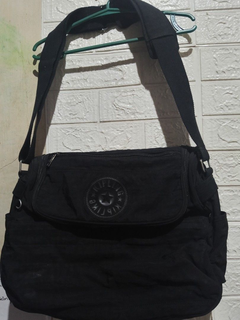 Black Kipling Shoulder Bag (Category: Shoulder Bags) located in Adams. Submitted by red__lee (Listing ID 1455196686, Image 1). Description: - Brand: Kipling - Color: Black - Material: Durable Nylon - Features: Multiple interior compartments for organization - Strap: Adjustable shoulder strap - Closure: Zipper are all working - Ideal for: Everyday use - Condition: Shows some signs of wear, but fully functional -Just need wash.
