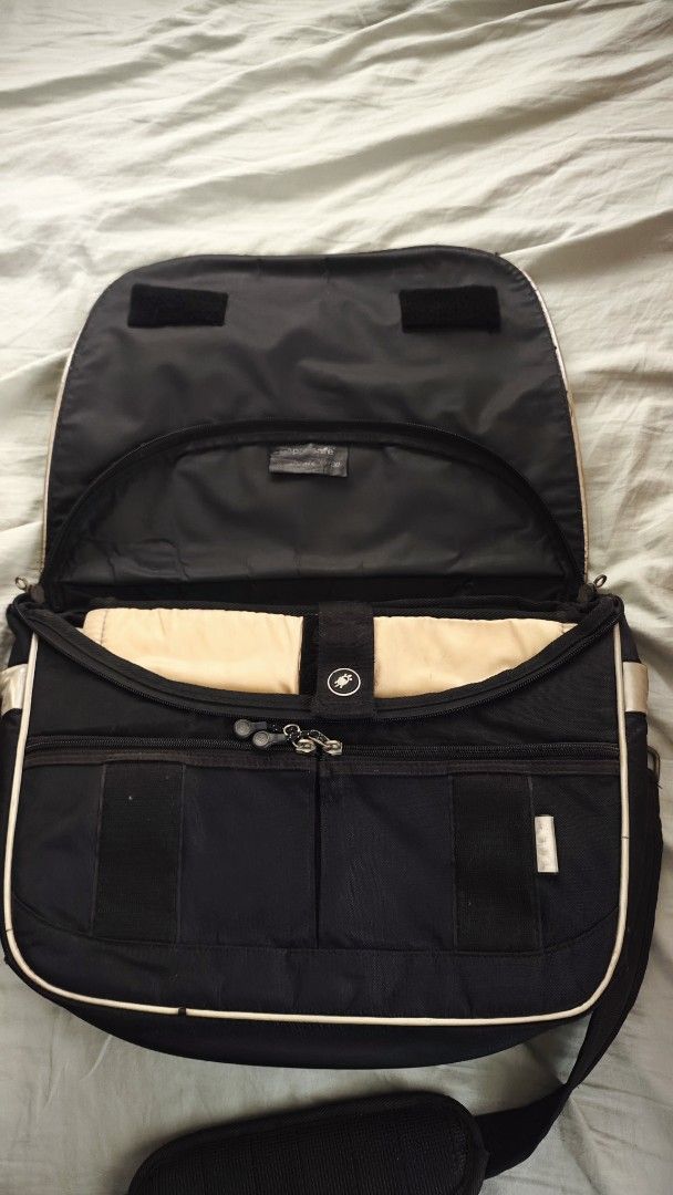 Black Messenger Bag with Tan Trim (Category: Luxury Bags & Wallets) located in Tarlac. Submitted by limidoloy191416 (Listing ID 1455206979, Image 2). Description: - Stylish black messenger bag with classic tan trim. - Spacious main compartment for your essentials. - Convenient front pockets for quick access. - Visible wear and tear on the top flap, as detailed in the close-up photo. - Adjustable shoulder strap for a comfortable fit. - Perfect for