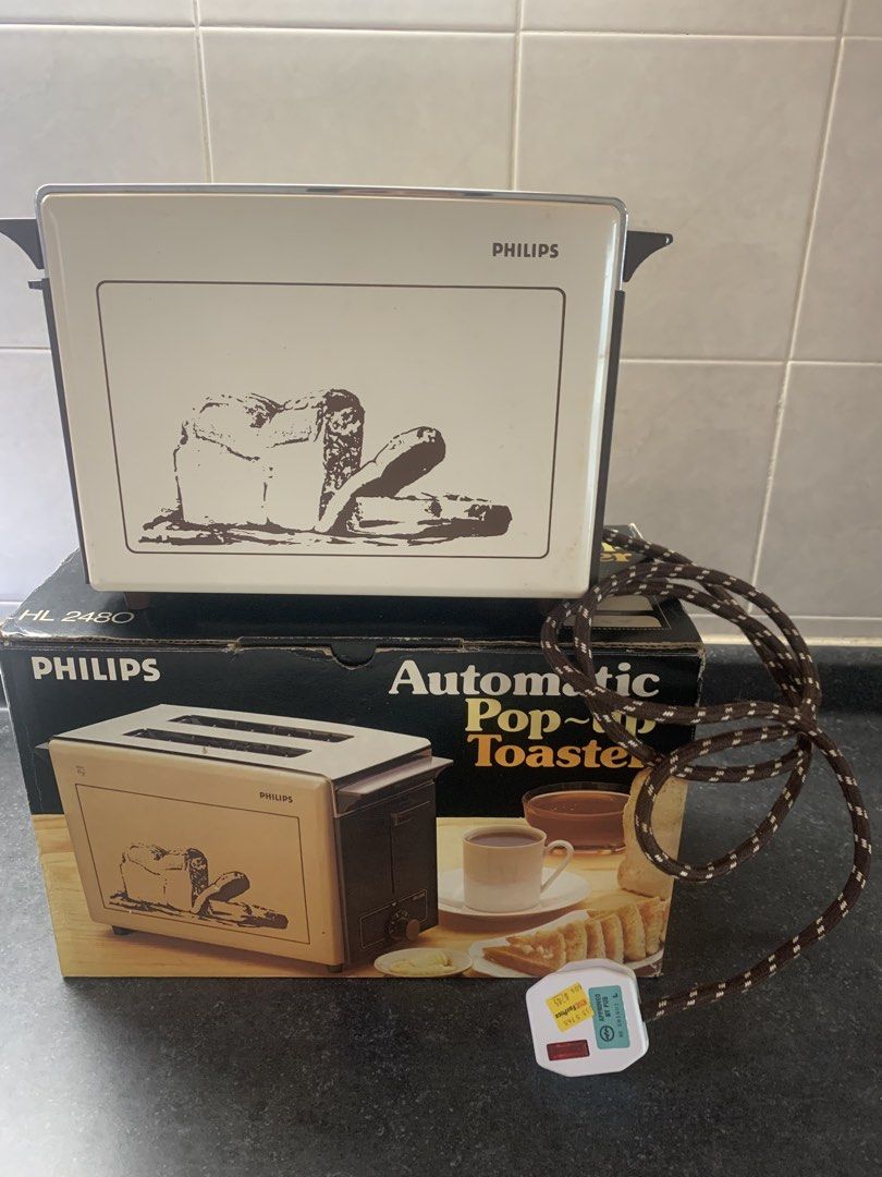 Bread toaster (Category: Ovens & Toasters) located in Singapore. Submitted by 123jap (Listing ID 1455212798, Image 1). Description: - Vintage Philips Automatic Pop-Up Toaster - Model: HL 2480 - Retro design with charming bread illustration - Classic cream and brown color scheme - Good working condition - Adds a nostalgic touch to any kitchen - Meetup available at Sengkang .