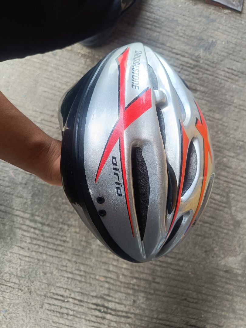 Bridgestone Airio Bicycle Helmet (Category: Bicycles) located in Manila. Submitted by rocksolid227 (Listing ID 1455189243, Image 1). Description: - Silver Bridgestone Airio helmet - Red and orange accents - Ideal for cycling - Shows minor scuffs from use - Ready for your next adventure.