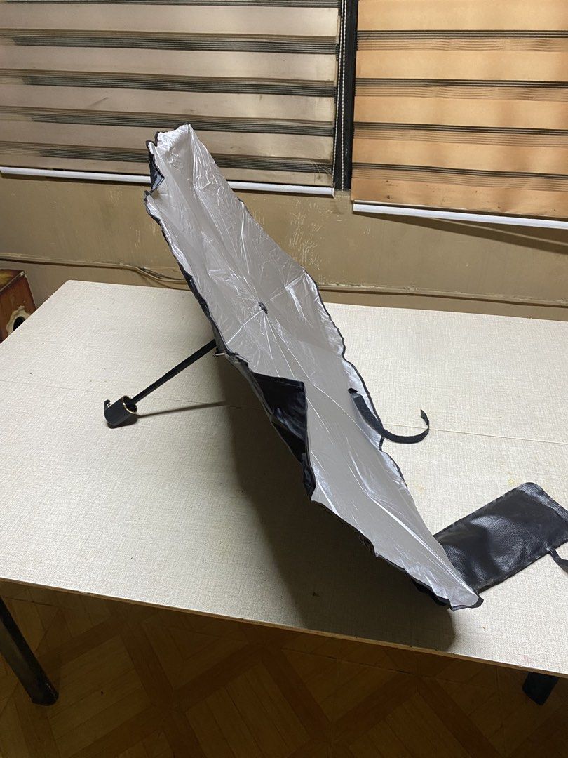 Car Sunshade Umbrella with Pouch - Silver (Category: Umbrellas) located in Iba. Submitted by leovincee.1414 (Listing ID 1455267818, Image 2). Description: - Keep your car cool and protected from the sun. - Silver exterior reflects sunlight effectively. - Folds compactly into an included pouch for easy storage. - Simple to use and install. - Protects your car's interior from sun damage. - Designed to fit most car windshields..