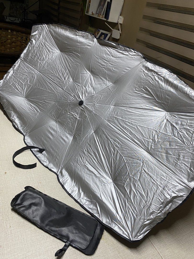 Car Sunshade Umbrella with Pouch - Silver (Category: Umbrellas) located in Iba. Submitted by leovincee.1414 (Listing ID 1455267818, Image 3). Description: - Keep your car cool and protected from the sun. - Silver exterior reflects sunlight effectively. - Folds compactly into an included pouch for easy storage. - Simple to use and install. - Protects your car's interior from sun damage. - Designed to fit most car windshields..