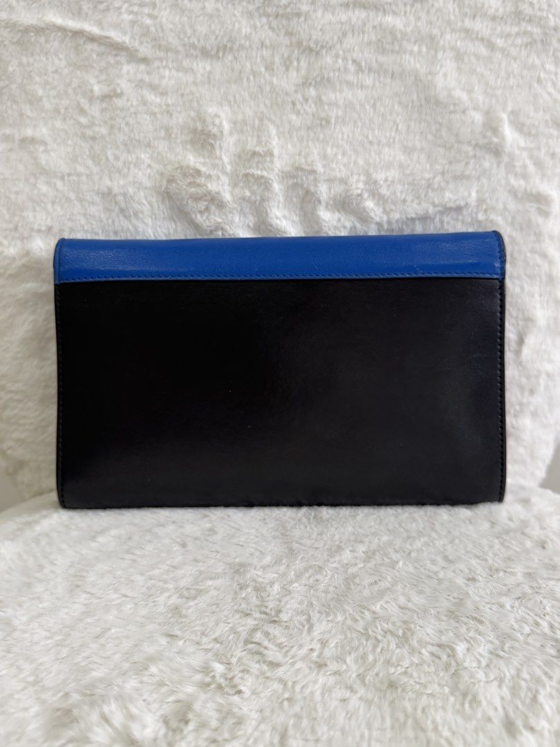FASTBREAK SALE Celine Tri-Color Leather Envelope Wallet on Chain (Category: Luxury Bags & Wallets) located in Quezon City. Submitted by closet24 (Listing ID 1455244515, Image 2). Description: - Celine Envelope Clutch - Colors: Black, Beige, Royal Blue Leather - Gold Chain Strap detachable - Snap Button Closure - Clean Interior No major flaws, only signs of use Rating 7.9/10 Not sure if touched up on the blue part hence the price. Inclusions Dust 