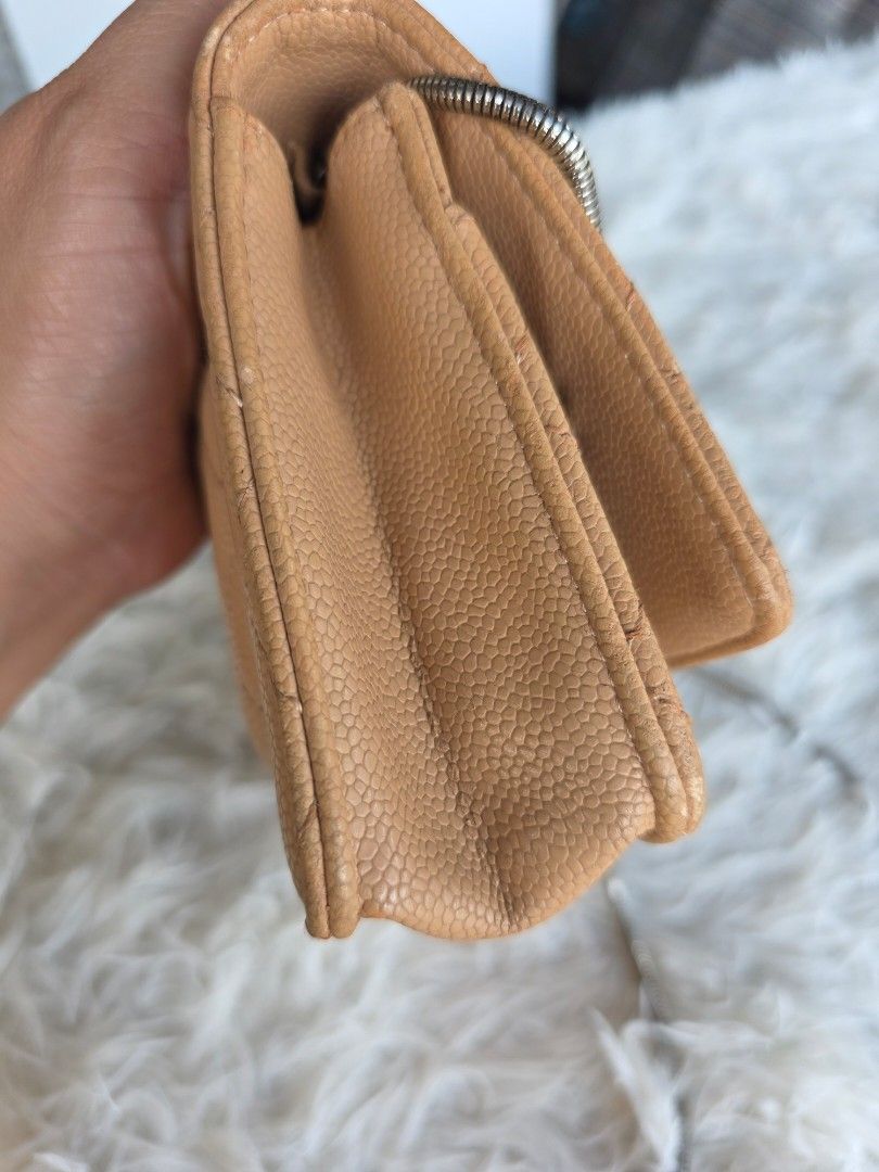 Chanel Quilted Caviar Leather Wallet (Category: Luxury Bags & Wallets) located in Lemery. Submitted by venus23 (Listing ID 1455320126, Image 2). Description: - Classic Chanel wallet in beige caviar leather - Features iconic diamond quilting and CC logo hardware - Multiple card slots and zippered compartments - Timeless piece for your essentials - Shows some signs of wear on edges and corners, consistent with regular use.