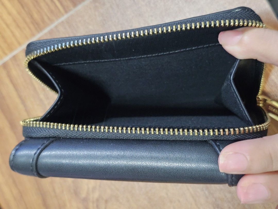 Charles & Keith Black Leather Tri-fold Wallet (Category: Wallets & Card holders) located in Paranaque City. Submitted by rhodalietagle (Listing ID 1455170900, Image 3). Description: - Brand: Charles & Keith - Color: Black - Style: Tri-fold wallet - Material: Leather - Features: Multiple card slots, zipper coin compartment - Hardware: Gold details - Size: Compact, fits pockets/small bags - Condition: Clean interior - Bought 2023 .