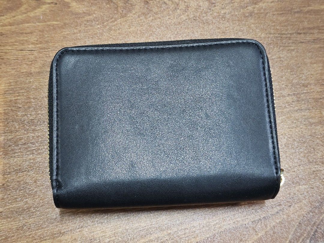 Charles & Keith Black Leather Tri-fold Wallet (Category: Wallets & Card holders) located in Paranaque City. Submitted by rhodalietagle (Listing ID 1455170900, Image 2). Description: - Brand: Charles & Keith - Color: Black - Style: Tri-fold wallet - Material: Leather - Features: Multiple card slots, zipper coin compartment - Hardware: Gold details - Size: Compact, fits pockets/small bags - Condition: Clean interior - Bought 2023 .