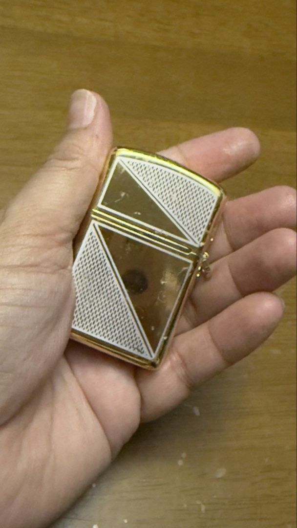 Chris Valentino Gold Lighter (Category: Fragrance & Deodorants) located in Pilar. Submitted by faveanyshop (Listing ID 1455248759, Image 3). Description: - Classic gold flip lighter - Engraved with 'CHRIS VALENTINO' - Features a patterned design - Ideal for collectors or everyday use.