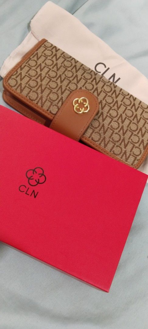 CLN Monogram Wallet with Box and Dust Bag (Category: Luxury Bags & Wallets) located in Cebu City. Submitted by angelrouge (Listing ID 1455154666, Image 2). Description: - CLN monogram wallet - Color: Brown and Tan - Comes with original box and dust bag - Multiple card slots and clear ID window - Secure snap closure with gold clover detail - Ideal for organizing your essentials buyer will shoulder the shipping or delivery fee Location: Cebu City.
