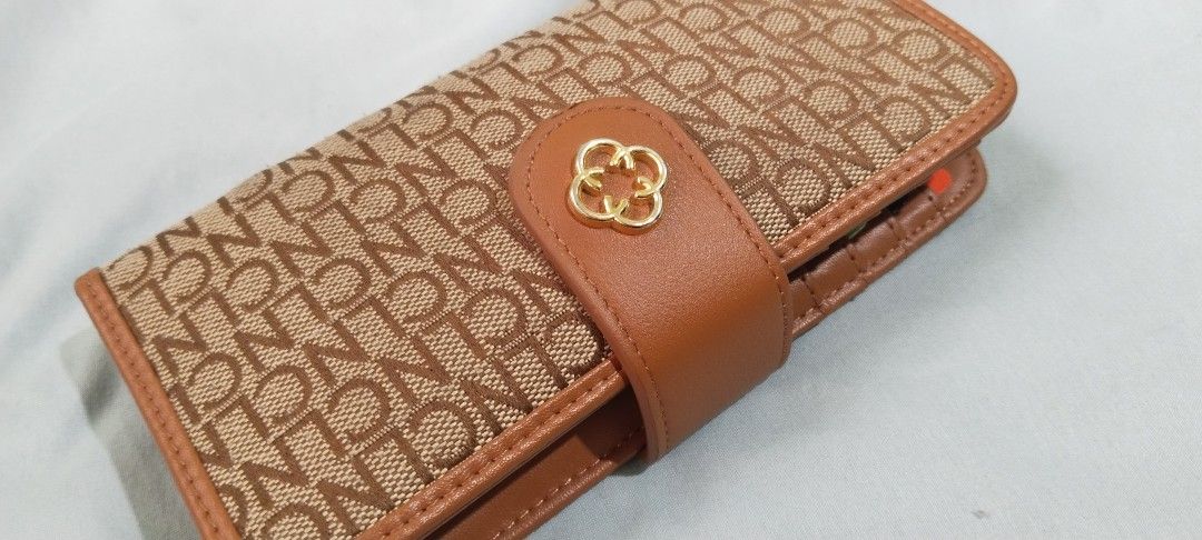 CLN Monogram Wallet with Box and Dust Bag (Category: Luxury Bags & Wallets) located in Cebu City. Submitted by angelrouge (Listing ID 1455154666, Image 1). Description: - CLN monogram wallet - Color: Brown and Tan - Comes with original box and dust bag - Multiple card slots and clear ID window - Secure snap closure with gold clover detail - Ideal for organizing your essentials buyer will shoulder the shipping or delivery fee Location: Cebu City.
