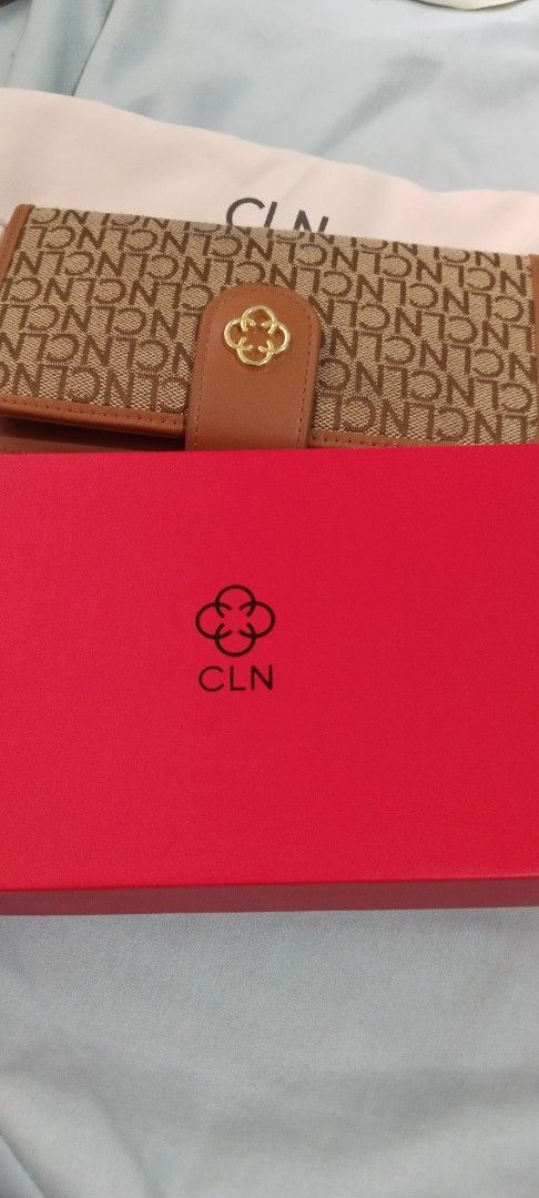 CLN Monogram Wallet with Box and Dust Bag (Category: Luxury Bags & Wallets) located in Cebu City. Submitted by angelrouge (Listing ID 1455154666, Image 3). Description: - CLN monogram wallet - Color: Brown and Tan - Comes with original box and dust bag - Multiple card slots and clear ID window - Secure snap closure with gold clover detail - Ideal for organizing your essentials buyer will shoulder the shipping or delivery fee Location: Cebu City.