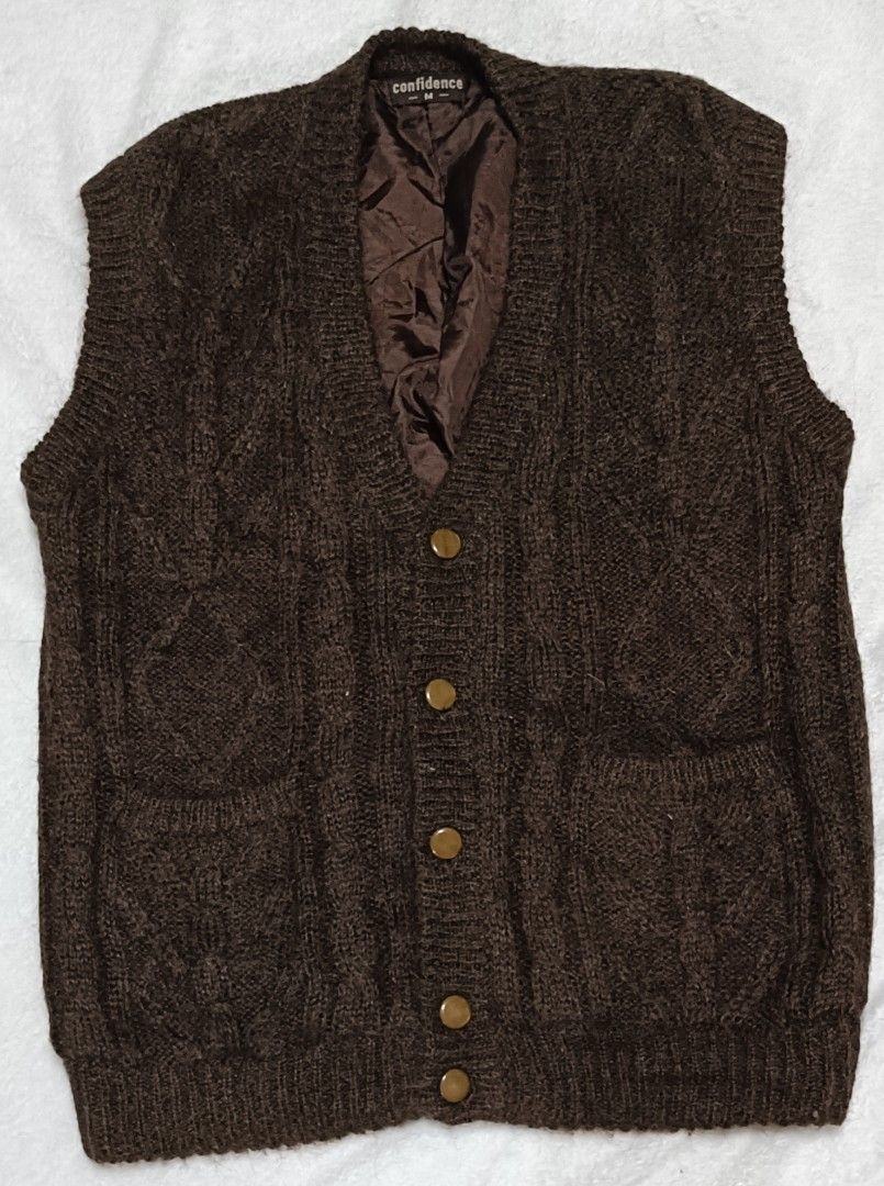 Confidence Brown Cable Knit Button-Up Vest (Category: Vests) located in Cabanatuan. Submitted by juantamadthirftshop (Listing ID 1455260591, Image 1). Description: - Brand: Confidence - Style: Brown cable knit vest - Features: Quilted lining, button-up front, two front pockets - Ideal for: Layering in cooler weather - Measurements: Pit to pit approx 22 inches, length approx 28 inches.
